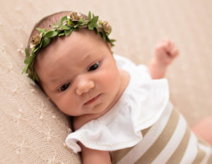 Awake baby girl posed in Rochester, NY.