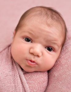 Sweet awake baby girl posed in Rochester, NY.