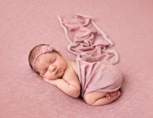 Cute newborn girl posed in our studio in Rochester, NY.