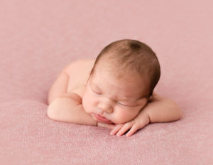 Infant girl in head on hands pose in Rochester, NY.