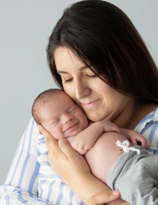 Mother and newborn posed at our in-home Rochester, NY studio.