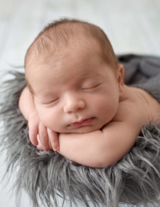 Precious newborn boy posed in our studio at Rochester, NY.