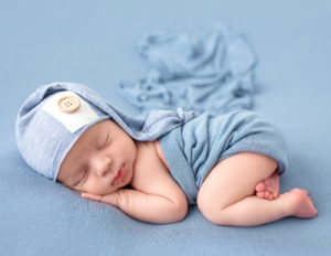 Newborn boy posed bum up in our Rochester, NY studio.