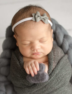 Beautiful newborn girl posed in our Rochester, NY studio.