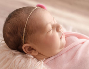 Profile of baby girl posed in our in-home studio in Greece, NY.