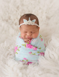 Newborn girl posed in our Rochester, NY studio.