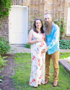 Pregnant couple posed in Rochester, Ny Highland Park.