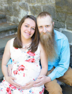 Pregnant couple posed at Highland Park in Rochester, Ny.