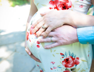 Pregnant woman posed in Rochester, Ny Highland Park.