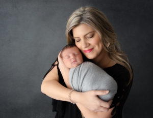 Mom posed with newborn son at our in-home Rochester, NY studio.