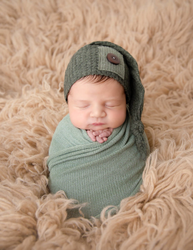 Adorable newborn boy posed in our studio in Rochester, NY.