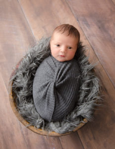 Awake newborn boy posed in our Rochester, NY studio.