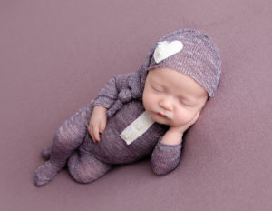 Sweet newborn girl posed in our Rochester, Ny studio.