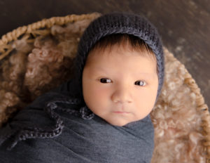 Awake newborn boy posed at our Rochester, NY studio.