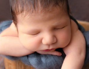 Cute newborn boy posed at our Rochester, NY studio.