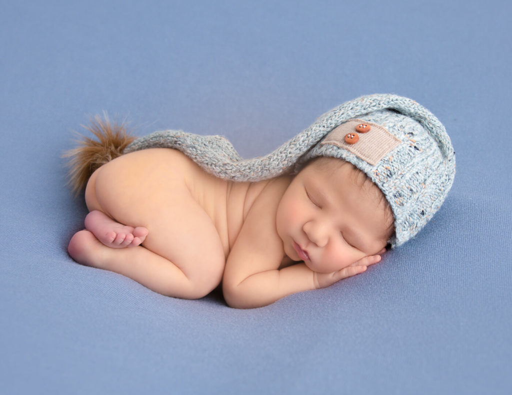 Newborn boy posed at our in-home Rochester, NY studio.