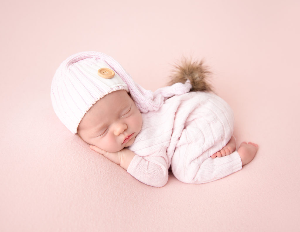 Precious newborn girl posed at our in-home Rochester, Ny studio.