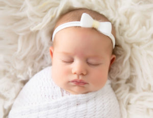 Sleeping 2 month newborn posed in our Rochester, NY studio.