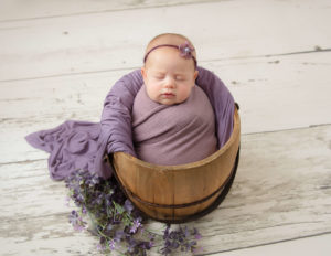 Sleeping newborn girl posed in our studio in Rochester, NY.