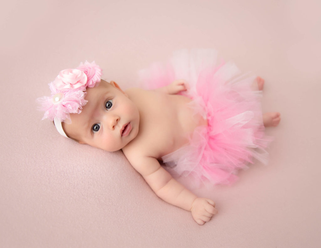 Cute newborn girl posed at our Rochester, NY studio.