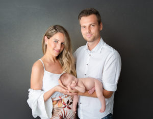 Parents with newborn posed at our studio in Rochester, NY.