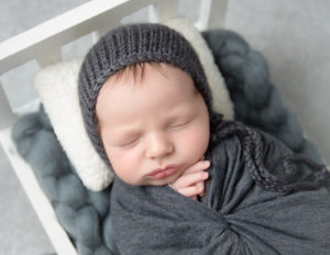 Sweet newborn boy posed at our studio in Rochester, NY.