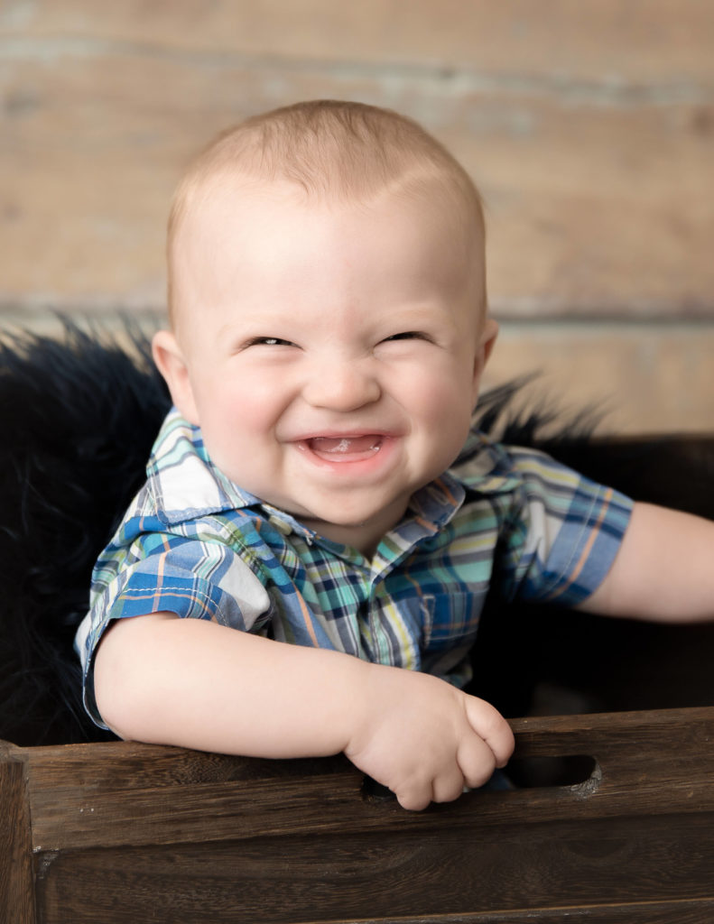 Six month milestone boy smiling at our studio in Rochester, Ny.