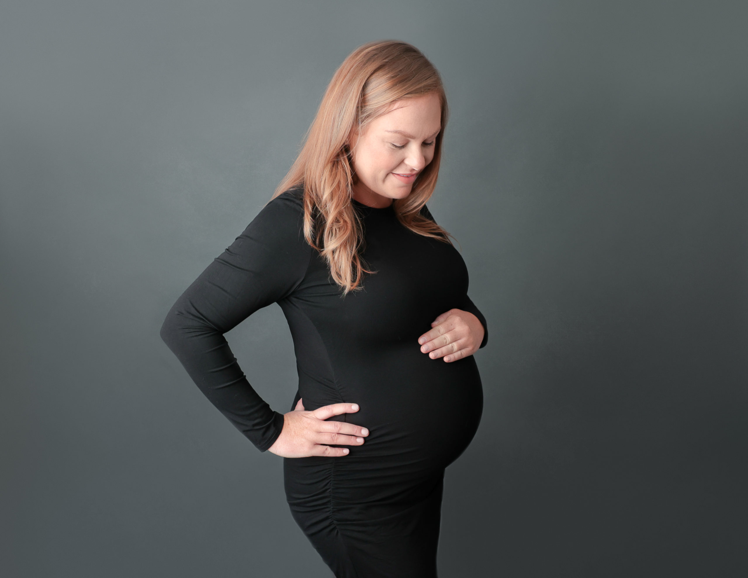 Glowing pregnant mom posed at her Maternity Session at our in-home studio.