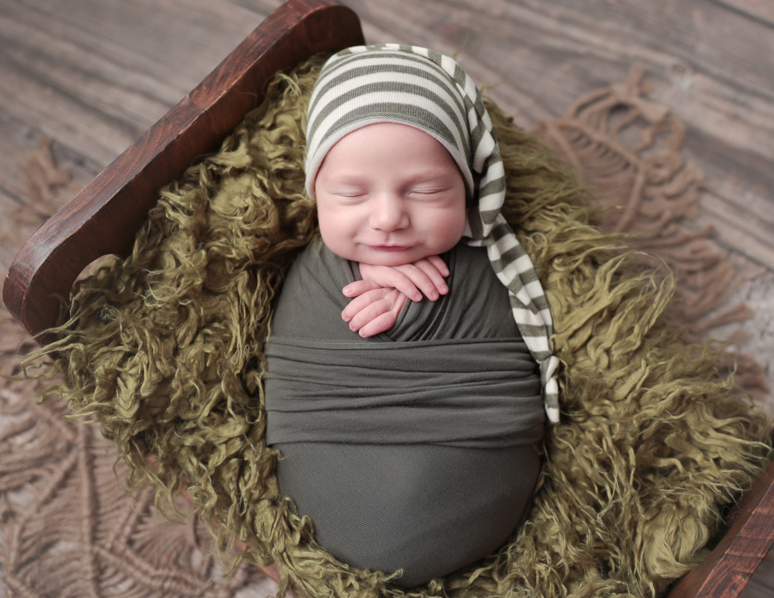 Smirking boy at our newborn portrait studio in Rochester, NY