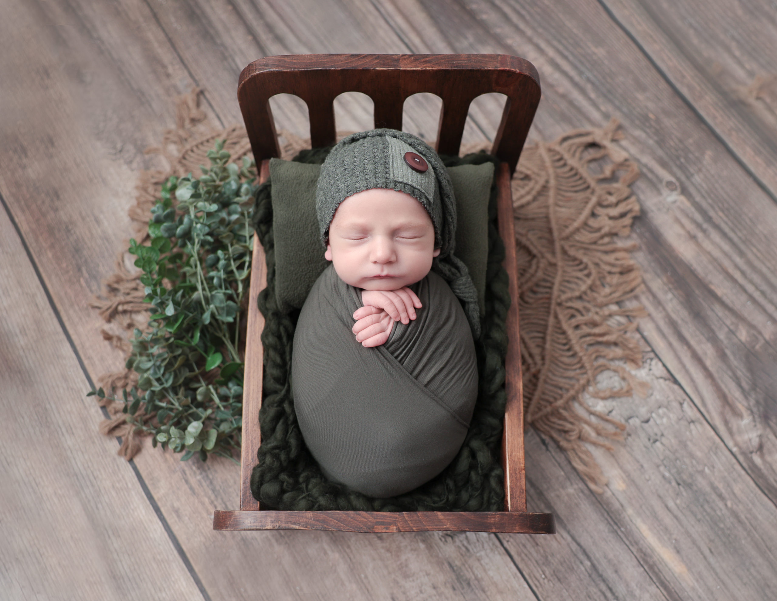 Baby in a bed at our studio in Rochester, NY