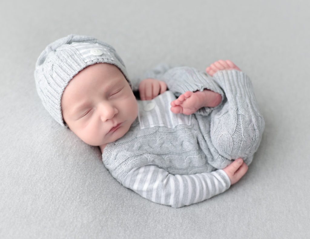 Sleeping baby boy posed at our Rochester, NY studio.