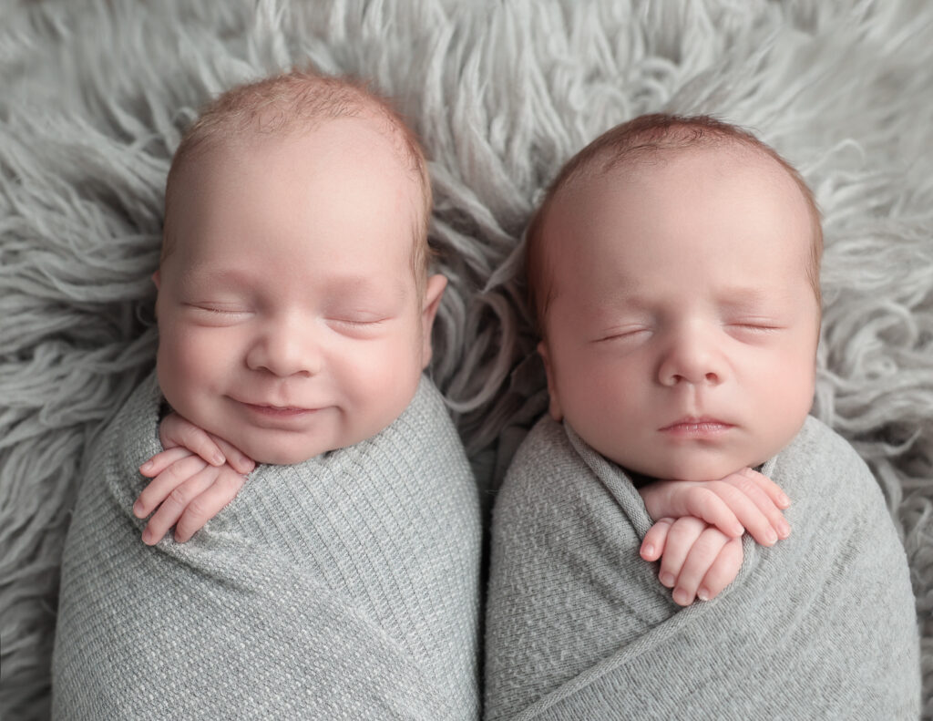 Twin newborn boys snuggled together, Rochester NY Photography.