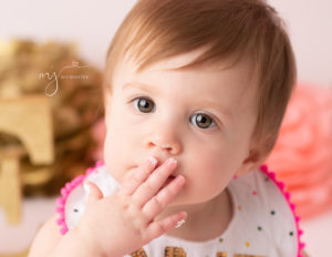 Adorable girl at cake smash at our Rochester, Ny studio.