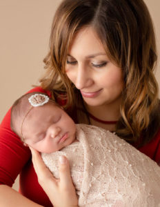New mom posed with her precious newborn daughter in Rochester, NY.