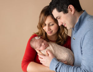 Parents with their newborn daughter in Rochester, NY.