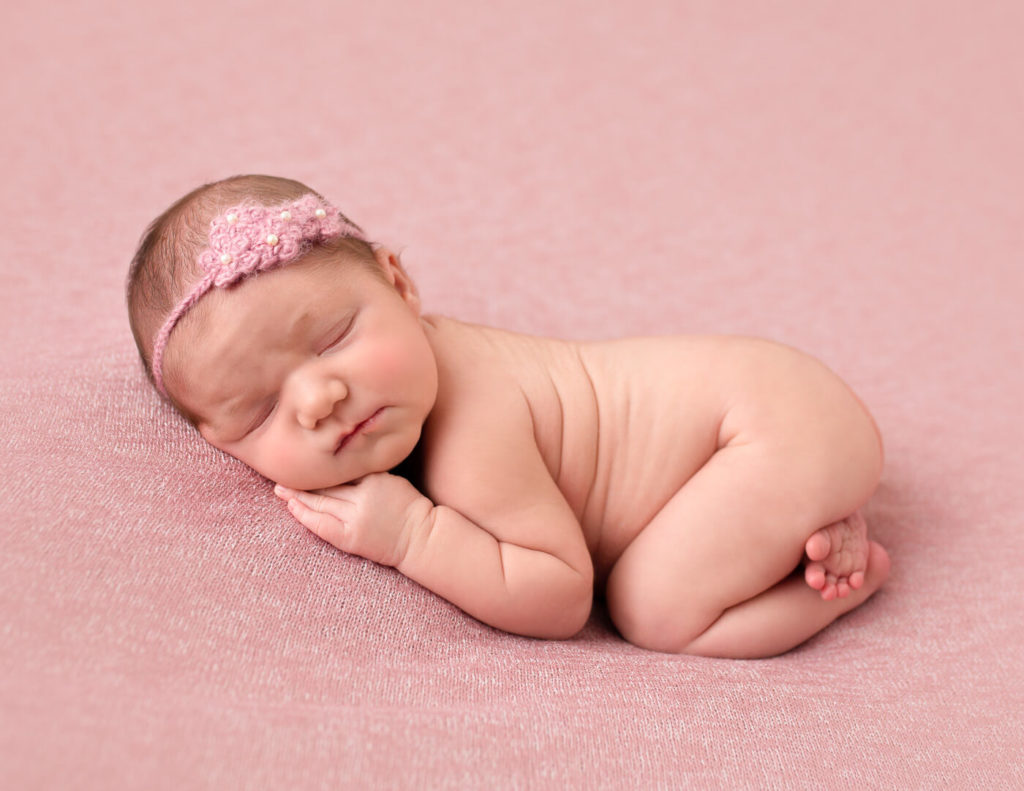 Cute newborn girl posed sleeping in Rochester, NY.