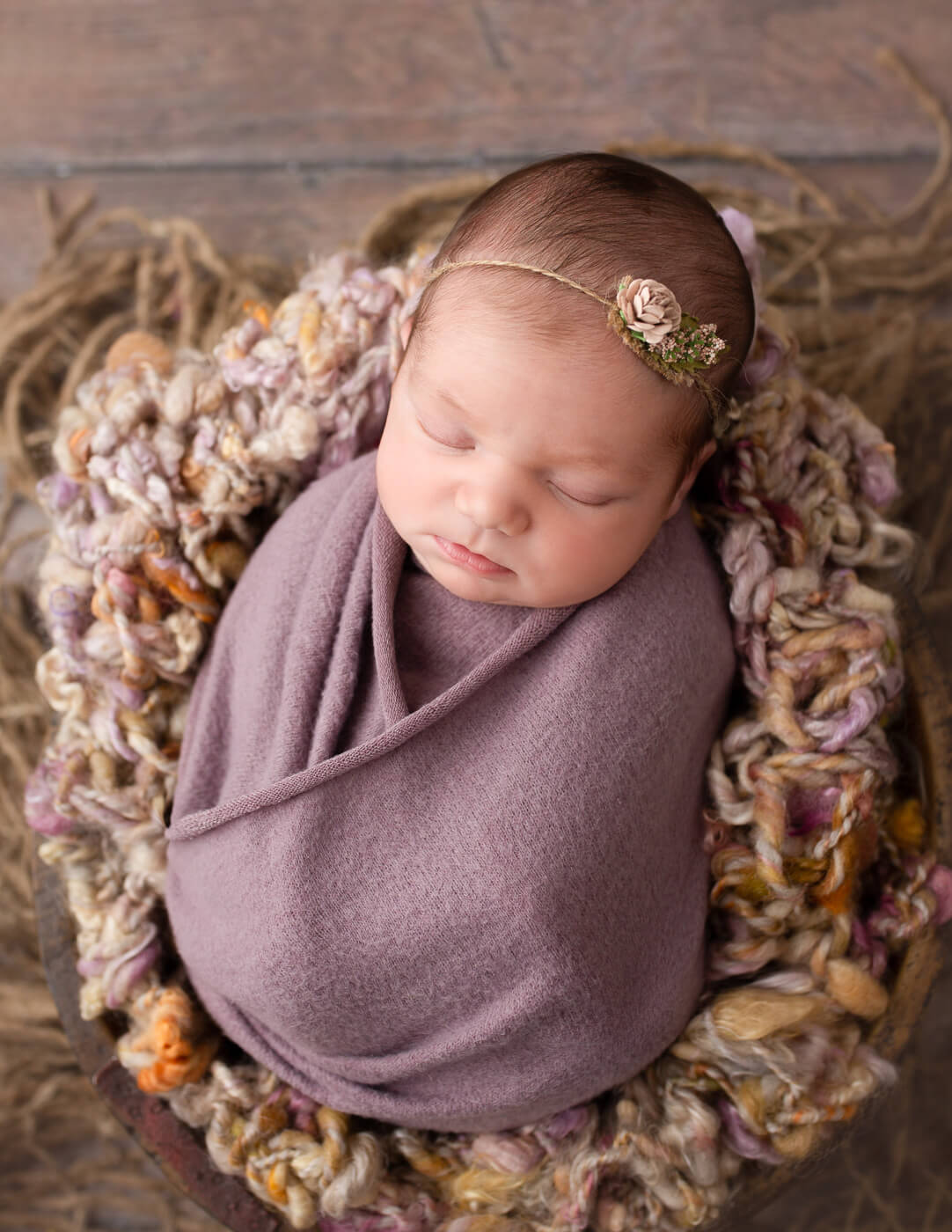 Sleepy newborn wrapped in our Rochester, NY studio.