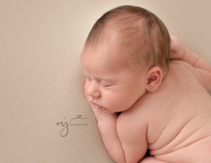Newborn boy in bum up pose at our Rochester, NY photo session.