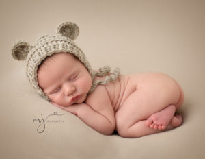 Newborn Photography baby boy in bum up pose with a teddy bear bonnet