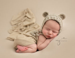 Sweet newborn boy in bum up pose in our studio in Rochester, NY.