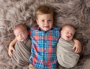 Big brother posed with twin brothers in our Rochester, NY studio.