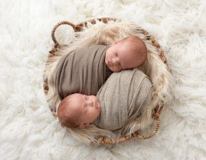 Precious twin newborn boys posed together in studio Rochester, NY.