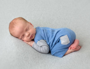 Newborn boy in bum up pose in our Rochester, Ny studio.