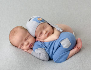 Twin newborn boys posed together at our Rochester, Ny studio.