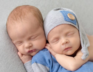 Twin newborn boys posed together at our in home Rochester, Ny studio.