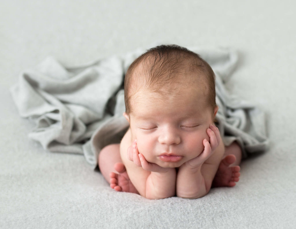 Newborn in froggy pose at our studio in Rochester, NY.
