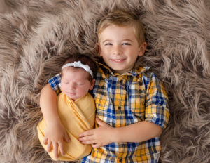 Siblings posed in our studio in Rochester, Ny.