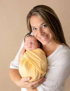 Mother and newborn daughter posed in our Rochester, Ny studio.