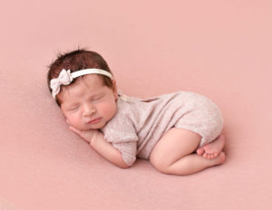 Sweet newborn girl posed in our in-home Rochester, Ny studio.