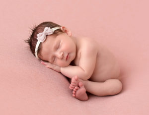 Sweet newborn girl in taco pose in our Rochester, Ny studio.